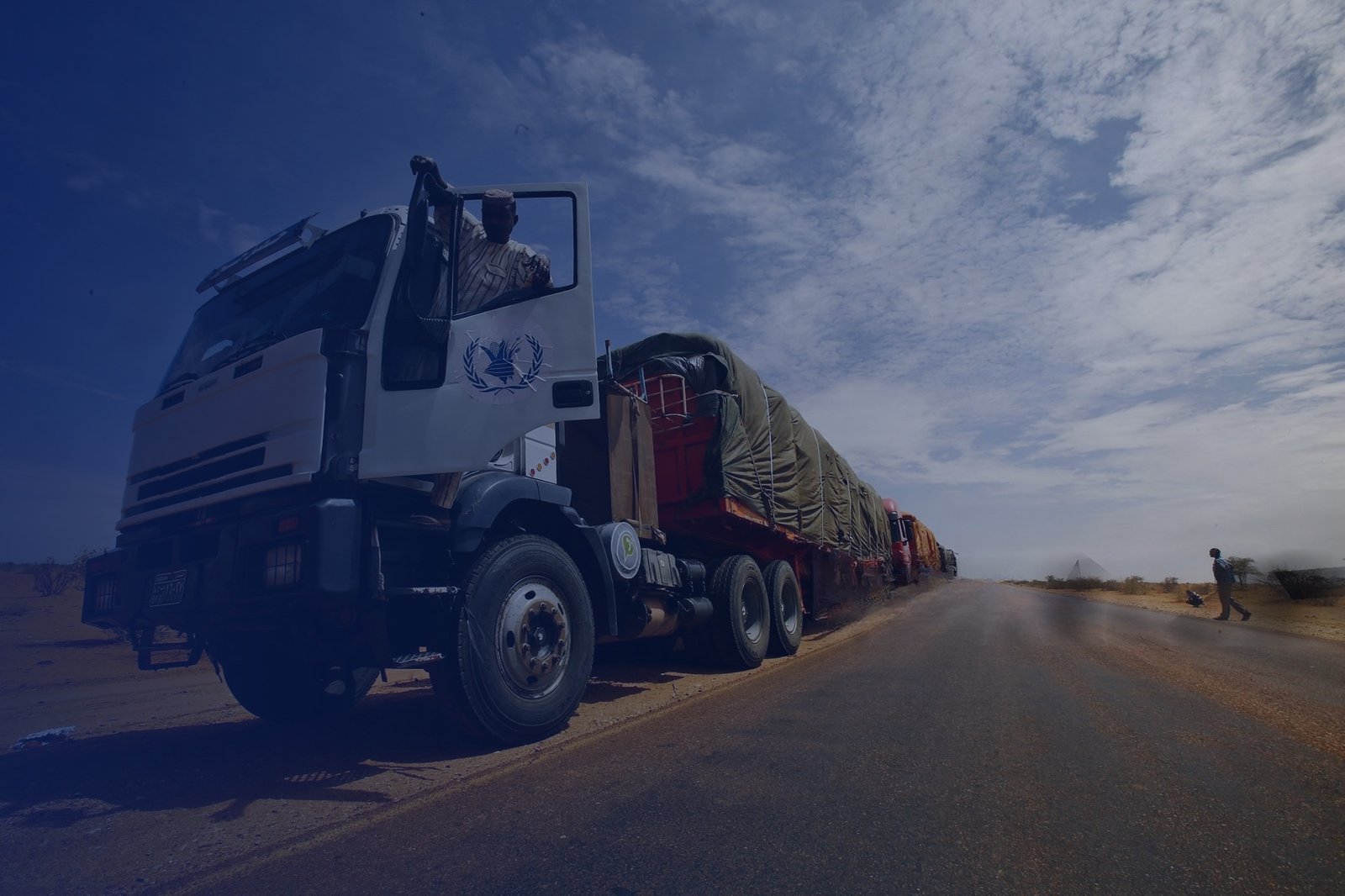 Humanitarian aid workers carrying supplies across East Africa